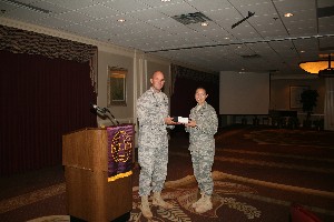 Capt. Johnson presents the Young AFCEAN award to 1st Lt. Melanie Alvarez, USAF, network systems flight operations officer, 34th Combat Communications Squadron, in September.